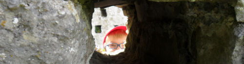 Boy looking through a hole