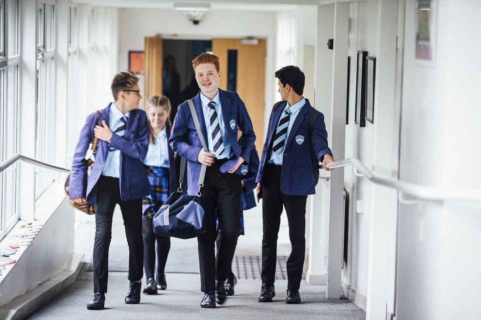 Young people walking down corridor