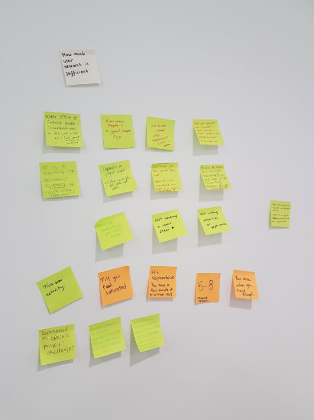 post it notes showing output of group discussion on user research